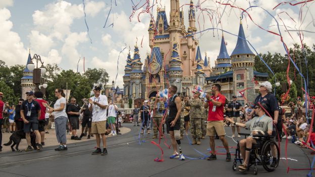 Athletes celebrating in front of Cinderella Castle - Walt Disney World Resort for the 2022 Department of Defense Warrior Games