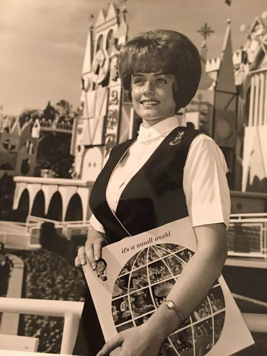 Connie Lane Swanson in front of "it's a small world"