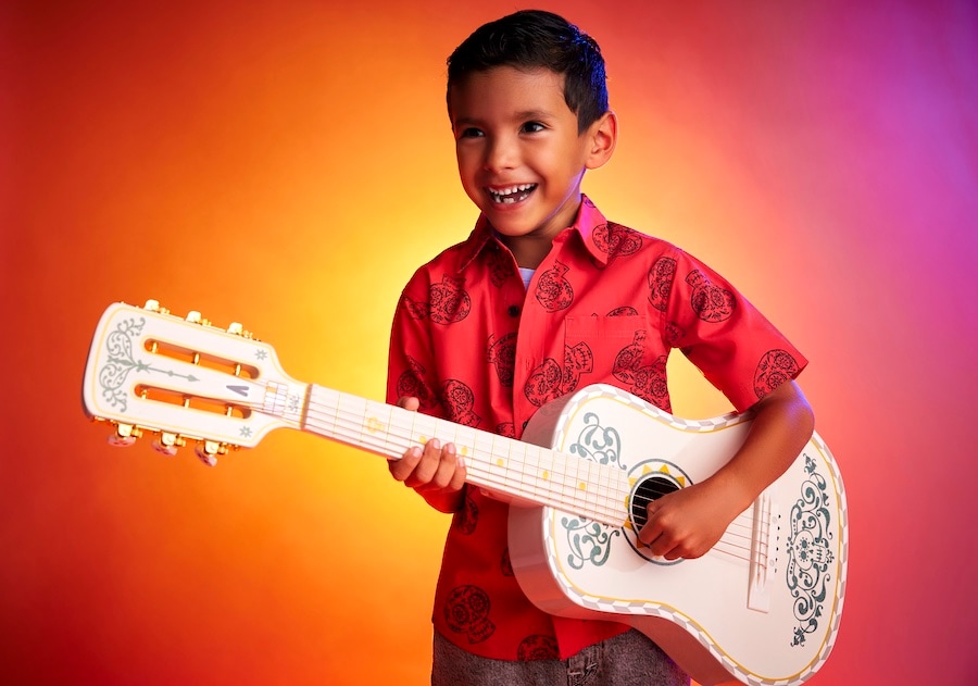 Boy playing a "Coco" guitar from shopDisney