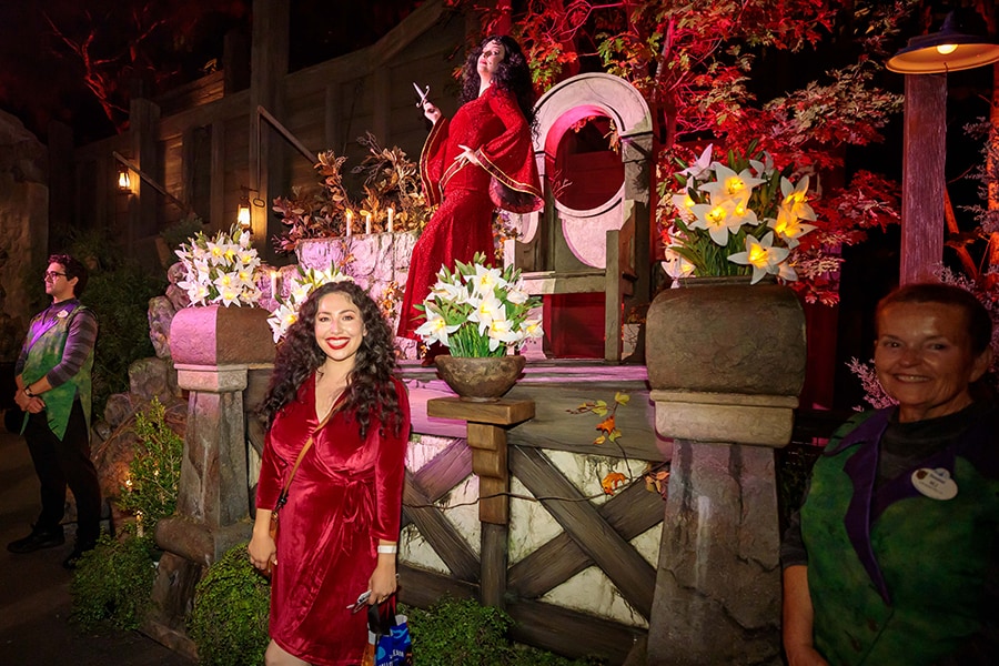 Mother Gothel looks on as a cast member dressed as her smiles