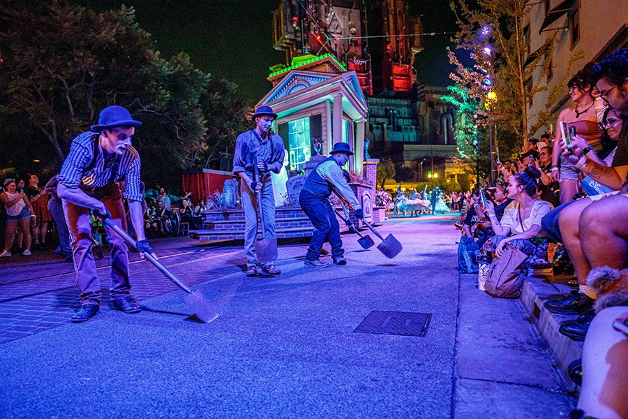 Gravediggers dance with shovels in hand during the Frightfully Fun Parade