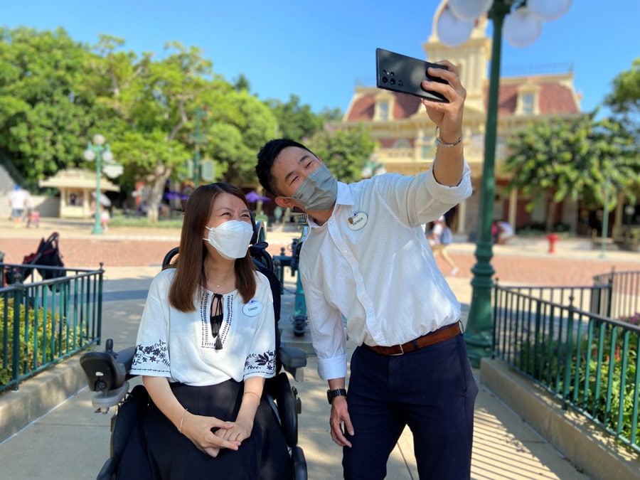 Candy Tsang takes a selfie with a fellow cast member in Town Square at Hong Kong Disneyland.