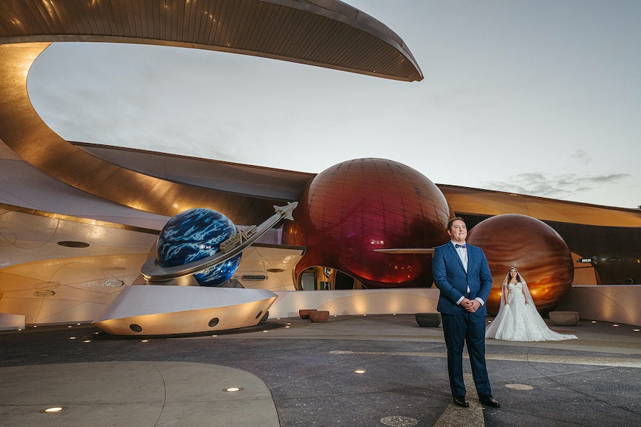 Bride and groom get a first look at each other in front of Mission: SPACE