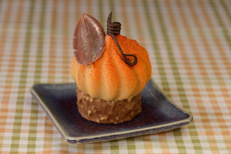 •	Pumpkin Mousse: Pumpkin mousse with pumpkin cheesecake and hazelnut chocolate cheesecake center on top spiced apple walnut cake, dipped in caramel milk chocolate, and toasted walnut shell 