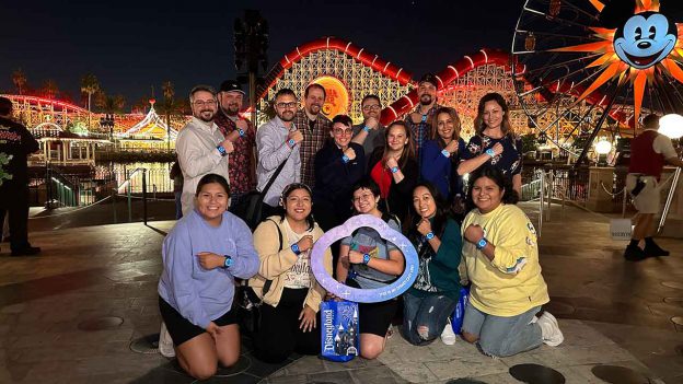 Cast members model their new MagicBand+ along Pixar Pier