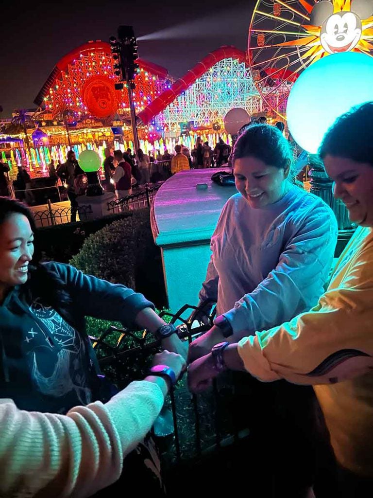 Cast members try out MagicBand+ at the World of Color viewing area