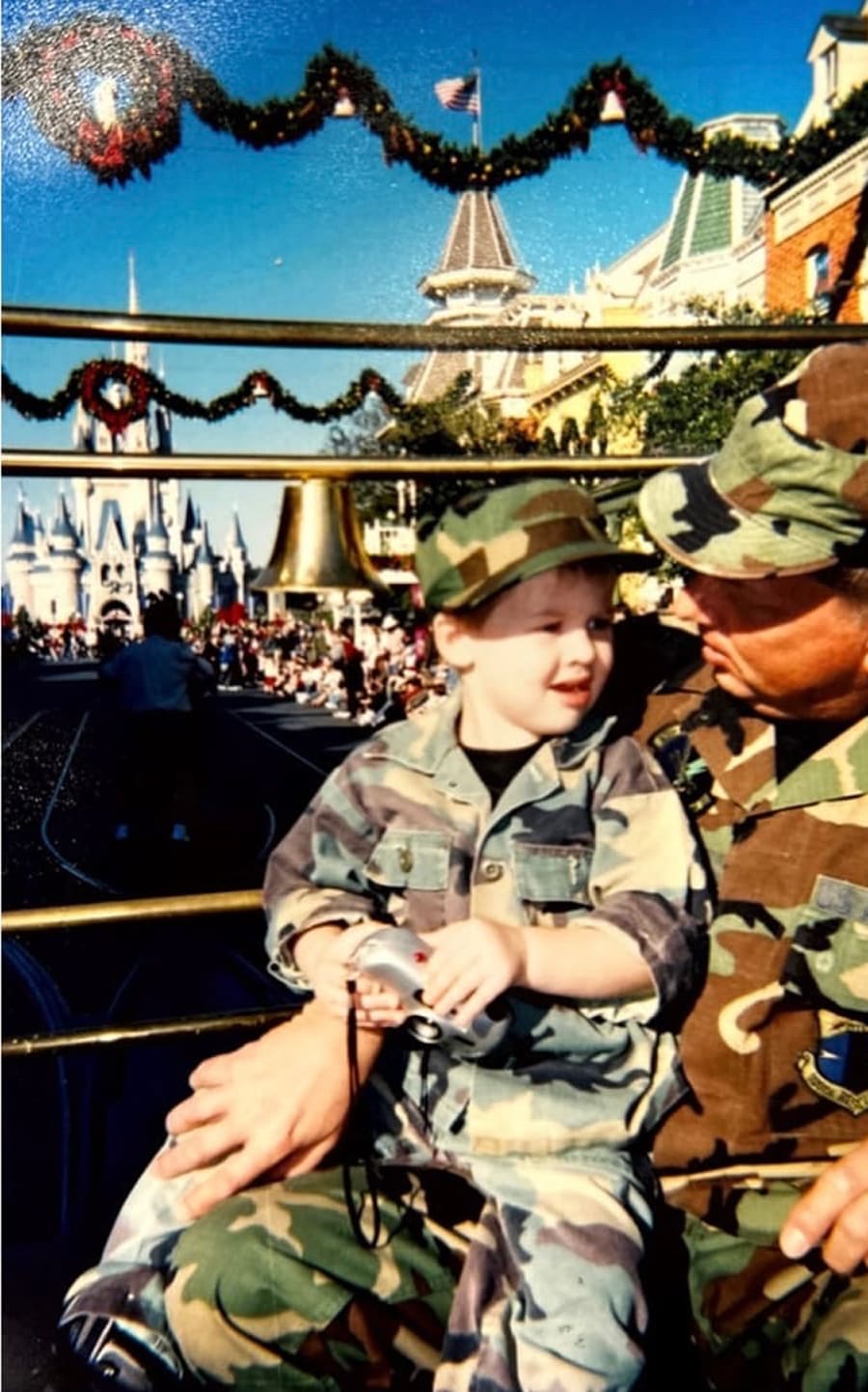 Ken Chapman and child in front of Cinderella's castle at Walt Disney World
