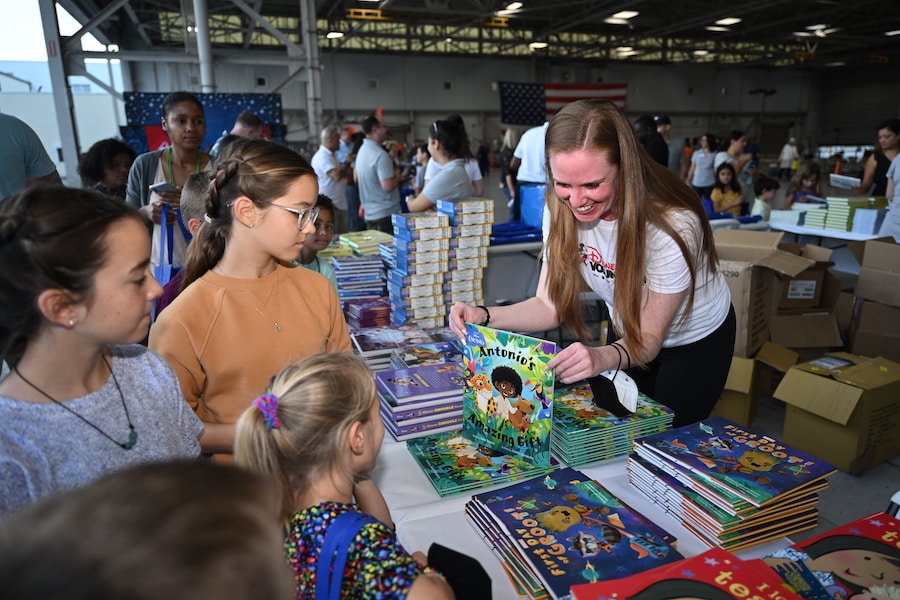 A Disney VoluntEAR showcases Disney Publishing’s book, “Antonio’s Amazing Gifts,” during the “Blue Star Books” event held in on Feb. 18, 2022 at U.S. Coast Guard Air Station in Opa-Locka, Fla. 