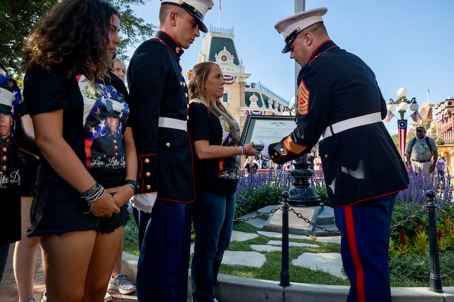The family of fallen Marine, Lance Cpl. Dylan Ryan Merola receives the Navy Achievement Medal from U.S. Marines in recognition of his valor and sacrifice to his country at Disneyland Resort on Aug. 8, 2022.