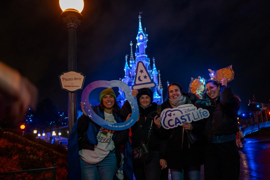Cast members at Disneyland Paris holding signs