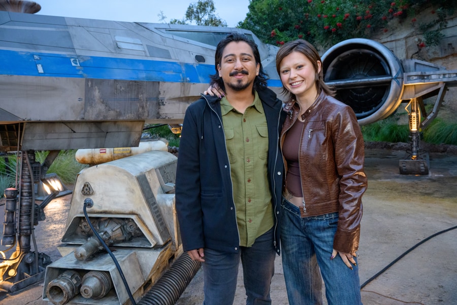 Willow cast Ruby Cruz and Tony Revolori in front of X-Wing at Star Wars Galaxy's Edge