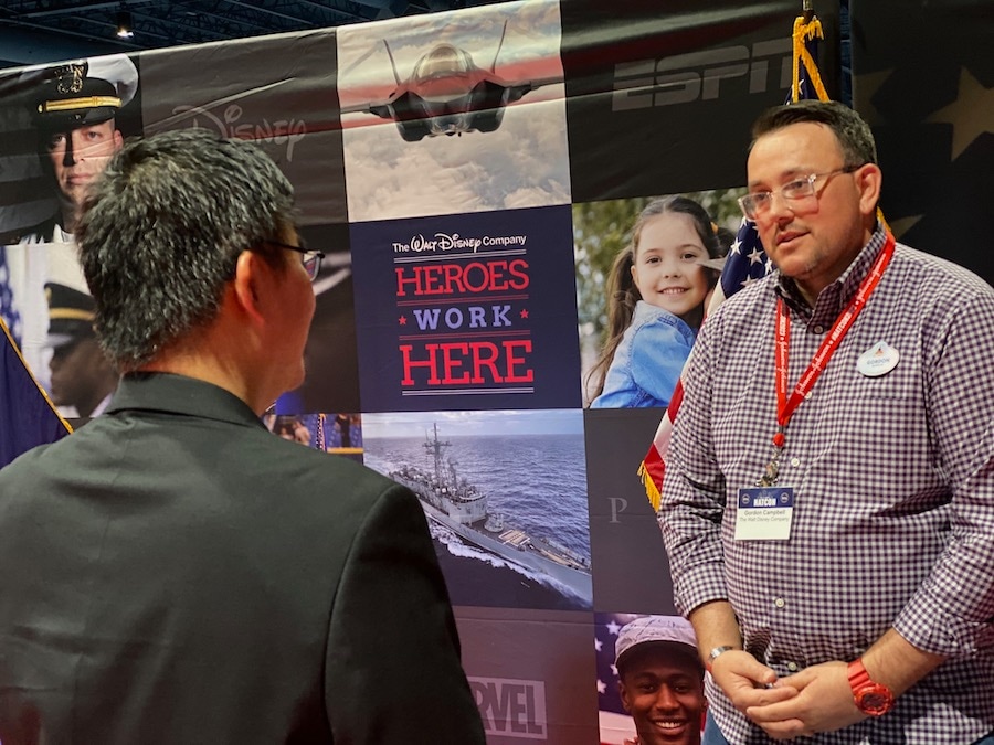 Disney cast member Gordon Campbell chats with an attendee of the 2023 Student Veterans of America National Conference at Walt Disney World Resort