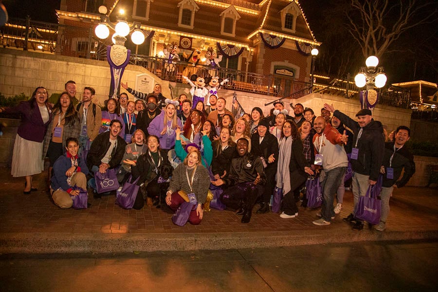 Cast members and Disney characters gathered on the Main Street, U.S.A. railroad station steps