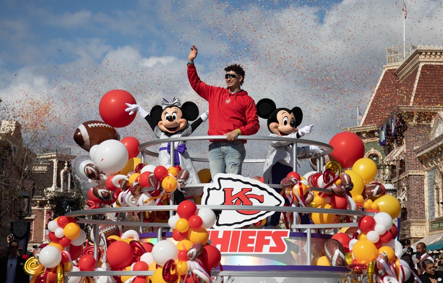 Patrick Mahomes Super Bowl MVP waves to guest on Kansas City Chiefs float with Mickey Mouse and Minnie Mouse on Main Street U.S.A at Disneyland Park.