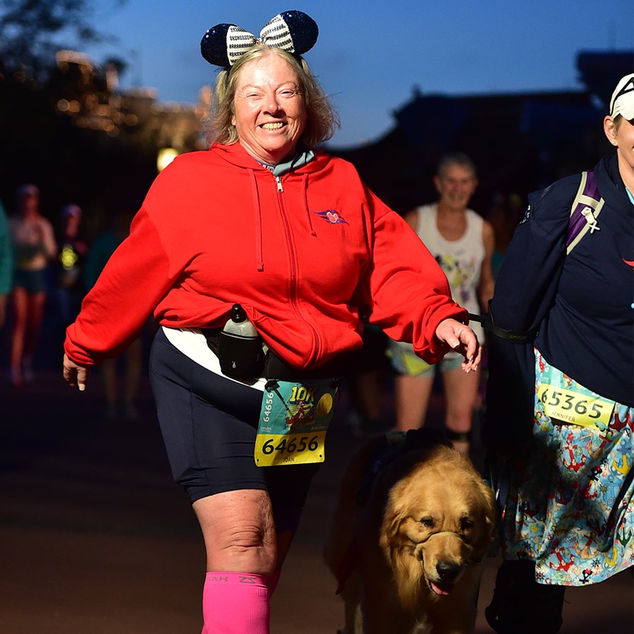 Joan smiles as she, Jennifer and Sulley participate in a runDisney race together.