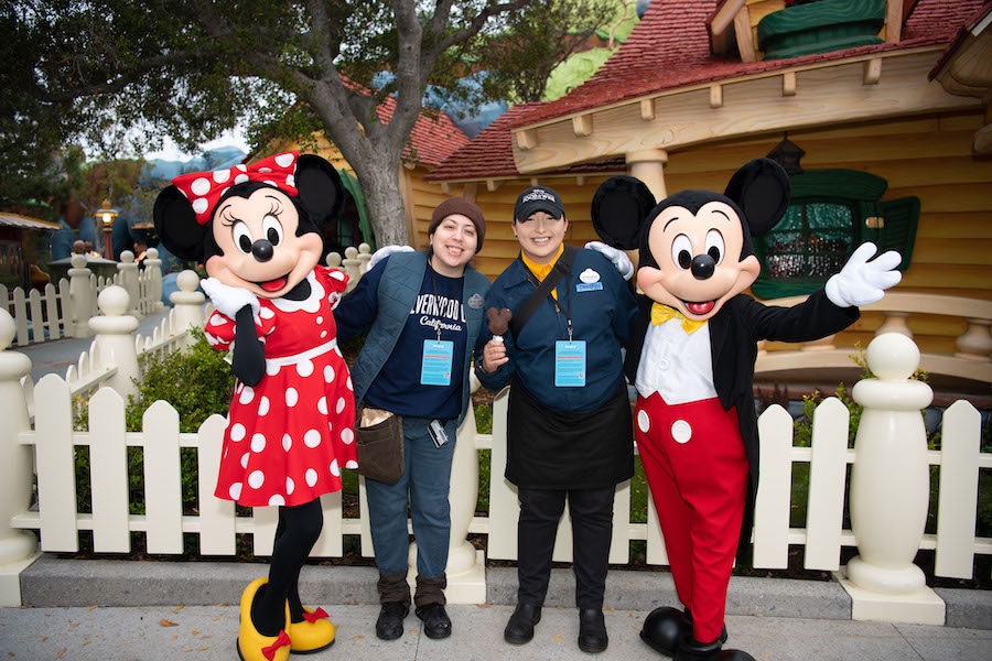 Mickey and Minnie Mouse pose with cast members