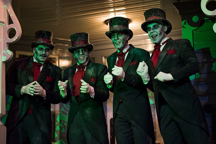 The Dapper Dans sing as the Cadaver Dans in black and red suits.