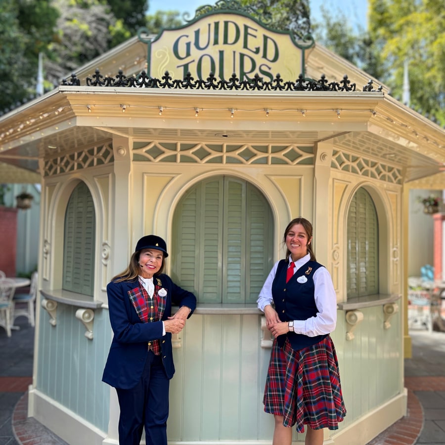 Cast members Paula and Sam in front of the Guided Tours booth