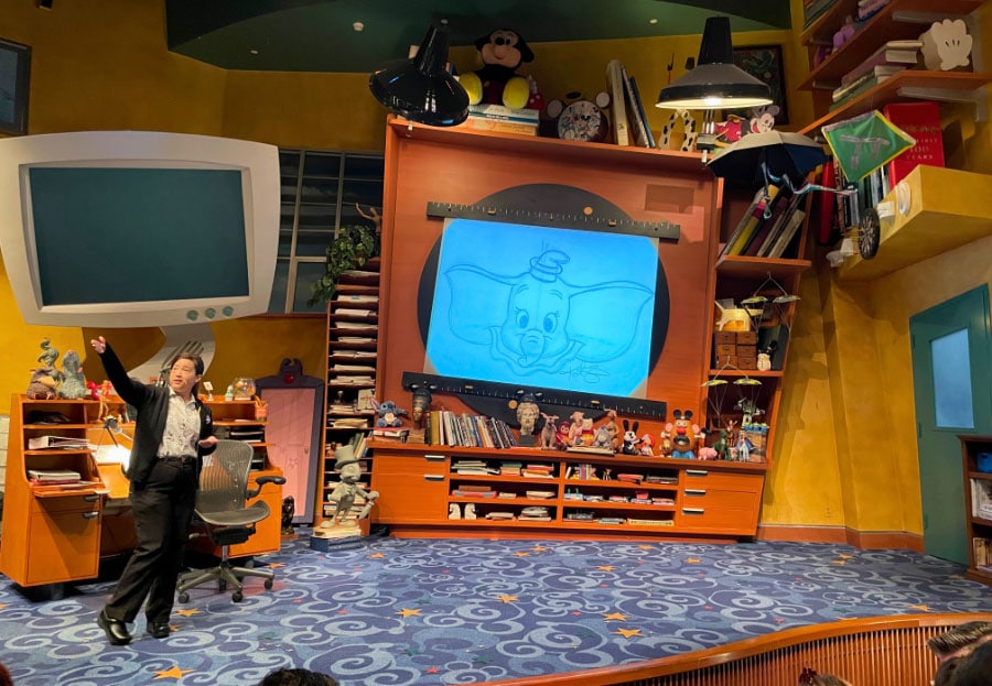 An artist addresses an audience from the Animation Academy stage