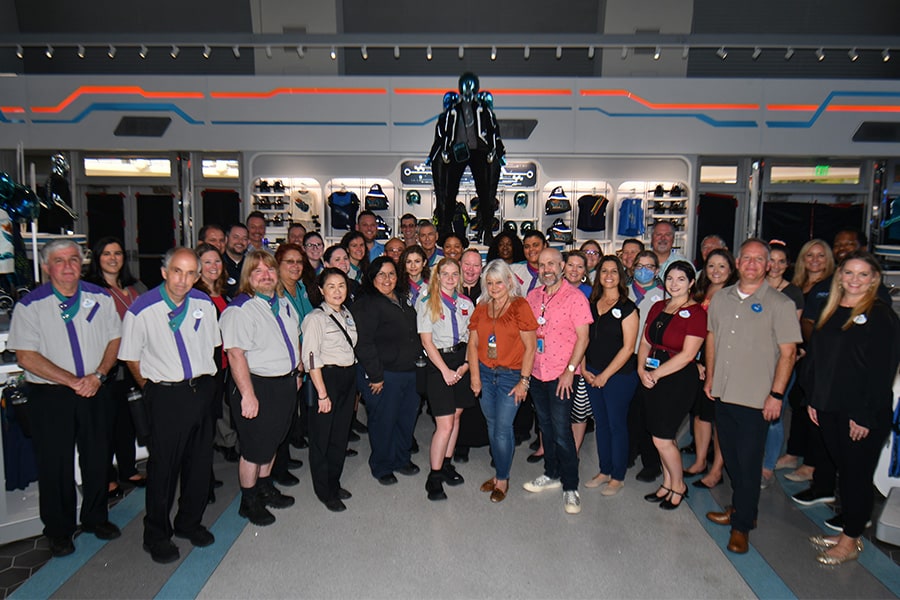 The cast of Tomorrowland Launch Depot smiles together in the store.