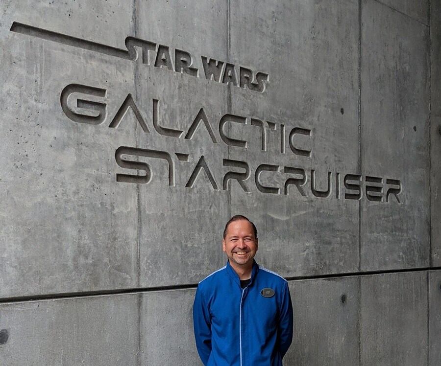 Jay standing in front of Stars Wars Galactic Starcruiser sign