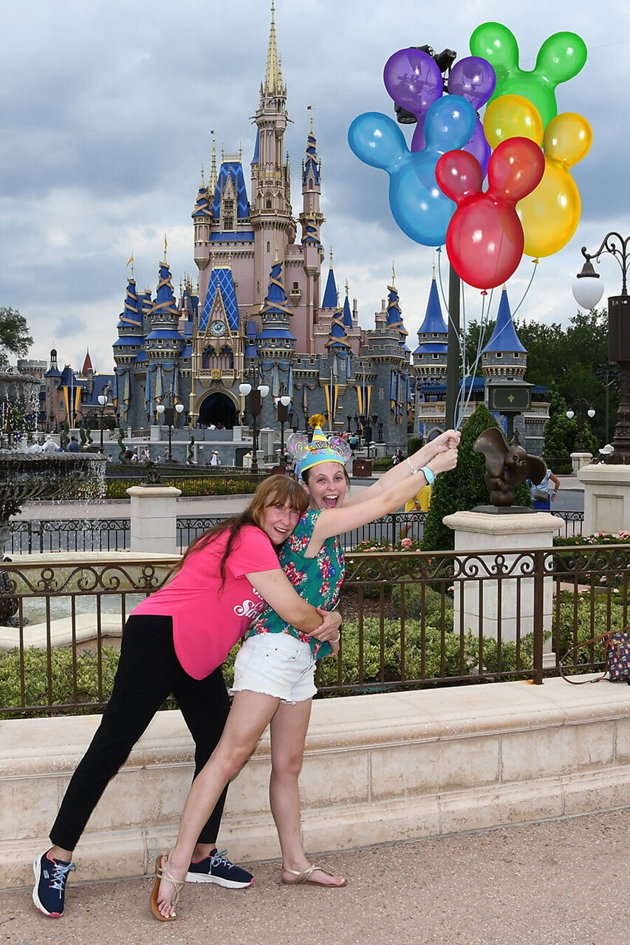 Rebecca and Sharlene smile in front of Cinderella Castle in a Disney PhotoPass shot for Rebecca's birthday.
