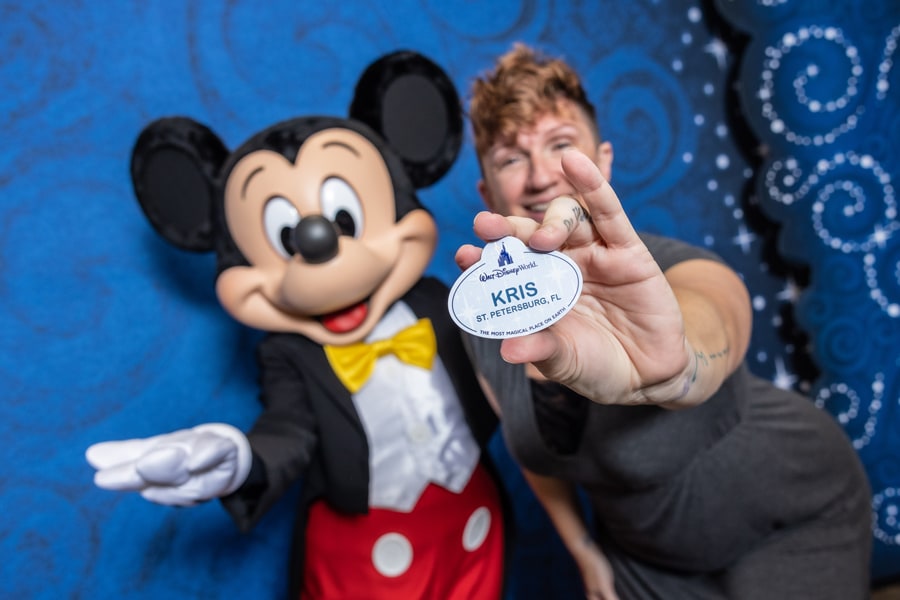Cast member holding new 2023 walt disney world name tag with Mickey Mouse