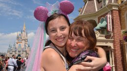Rebecca and Sharlene smile together in front of Cinderella Castle.