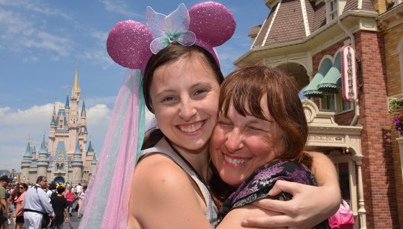 Rebecca and Sharlene smile together in front of Cinderella Castle.