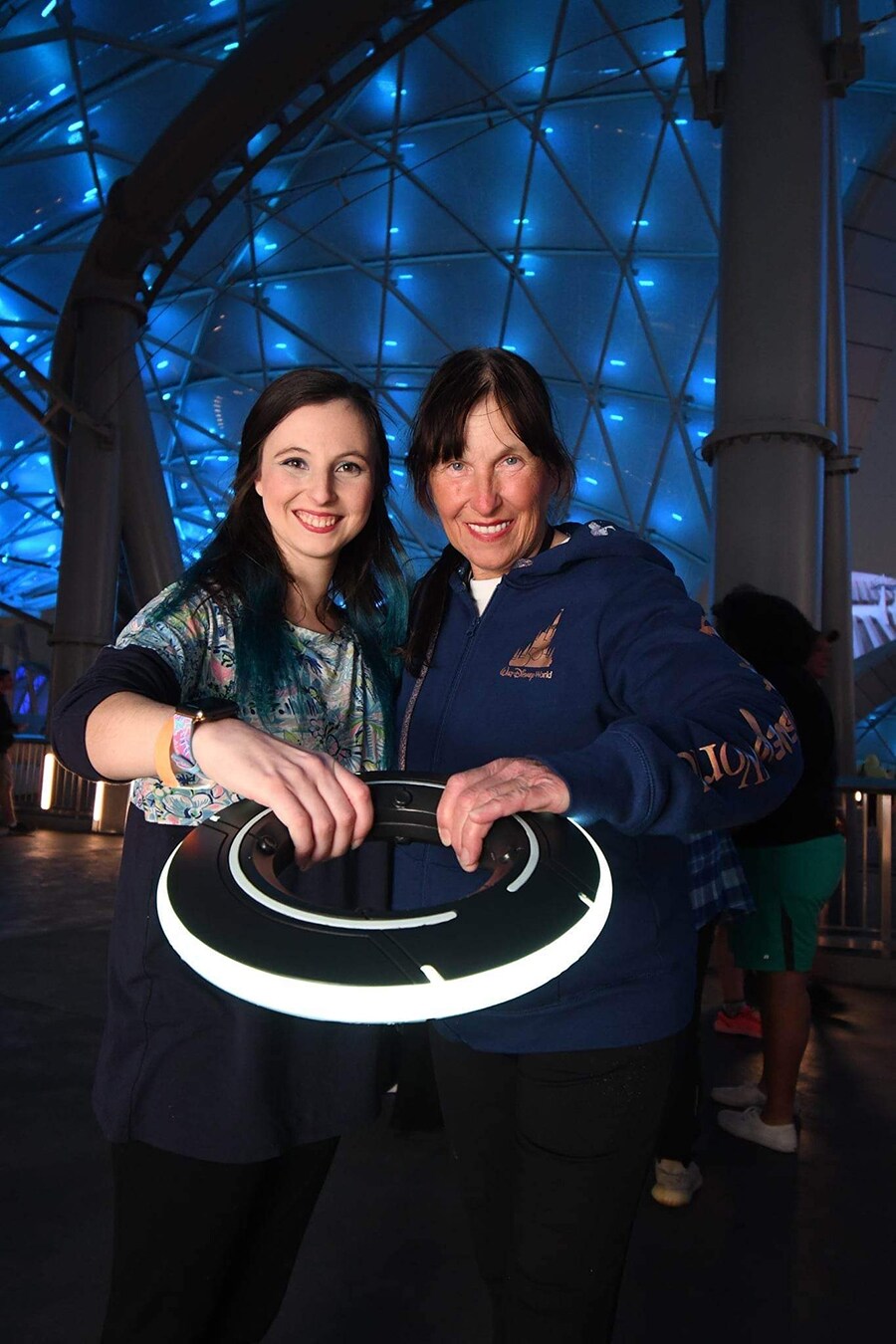 Rebecca and Sharlene smile in a PhotoPass picture at TRON Lightcycle / Run.