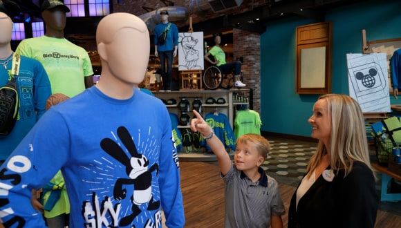 Channing smiles with Rachel and his mannequin inside World of Disney.