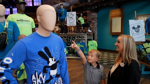 Channing smiles with Rachel and his mannequin inside World of Disney.