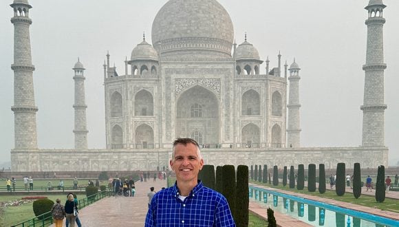Kyle smiles in front of the Taj Mahal