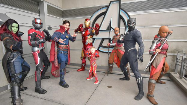 Colton poses in his Iron Man costume with all his new Super Hero friends at Avengers campus.