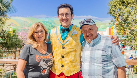 Gina, Al and Caden smile together at Mickey's Toontown.