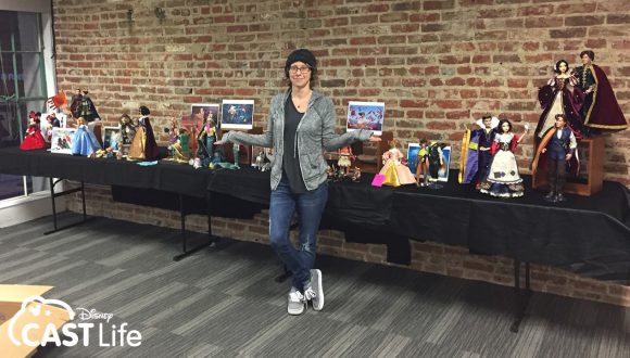 J smiles with dolls she's designed.