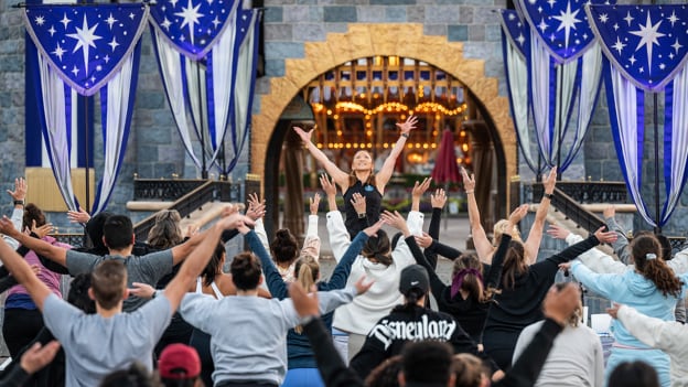 Cast Members do yoga in front of Sleeping Beauty Castle, Disneyland