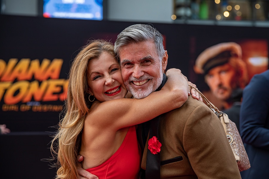 Disney Cast Member and Original Indiana Jones Epic Stunt Spectacular Indiana Jones and Marion performers embrace on the red carpet premiere