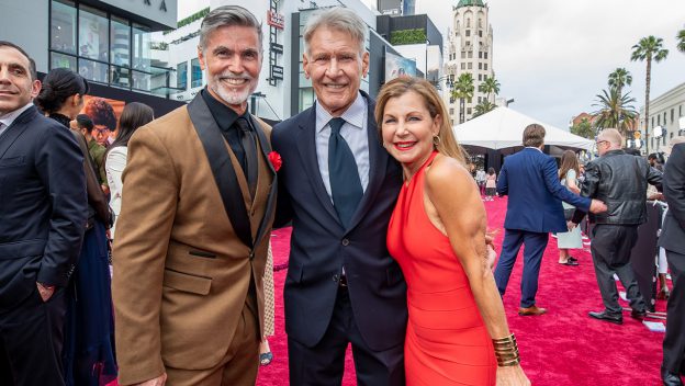 Harrison Ford posing with Disney Cast Member and original Indiana Jones Epic Stunt Spectacular Indy performer, Kevin Bassard, along with guest and cast member Michele Waitman