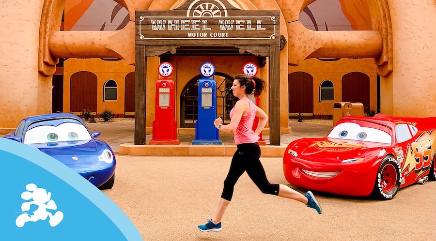 runDisney guest running with Cars movie characters in background