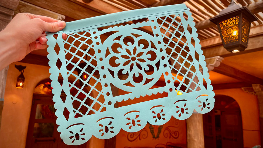 Light blue papel picado decoration held up within the dining room or restaurant