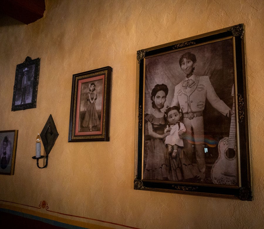 Family portraits hung on a wall within la Sala de Familia