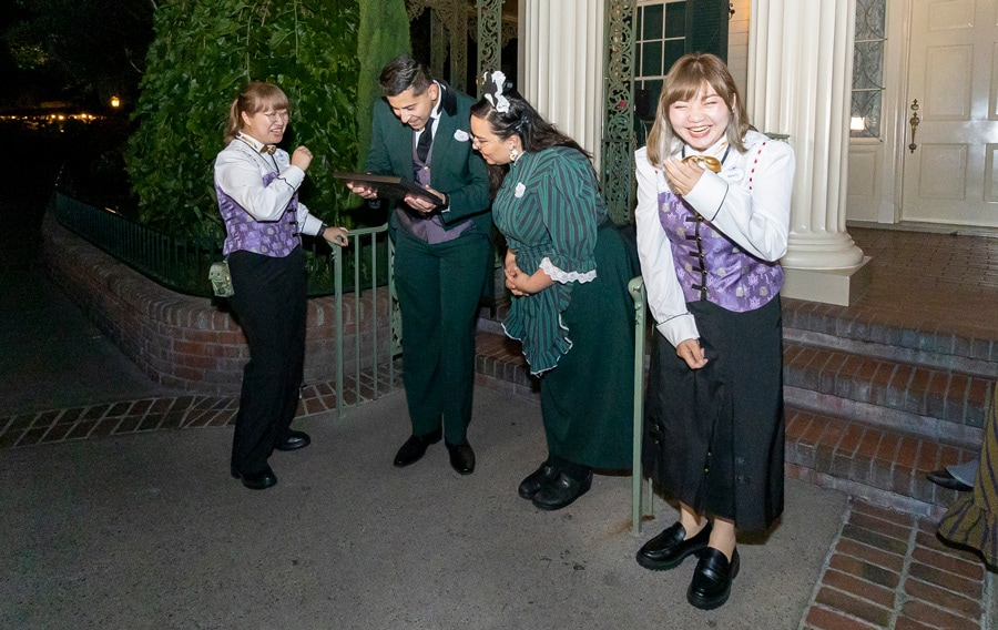 Mystic Manor cast laughing as they surprise Haunted Mansion cast with a special portrait