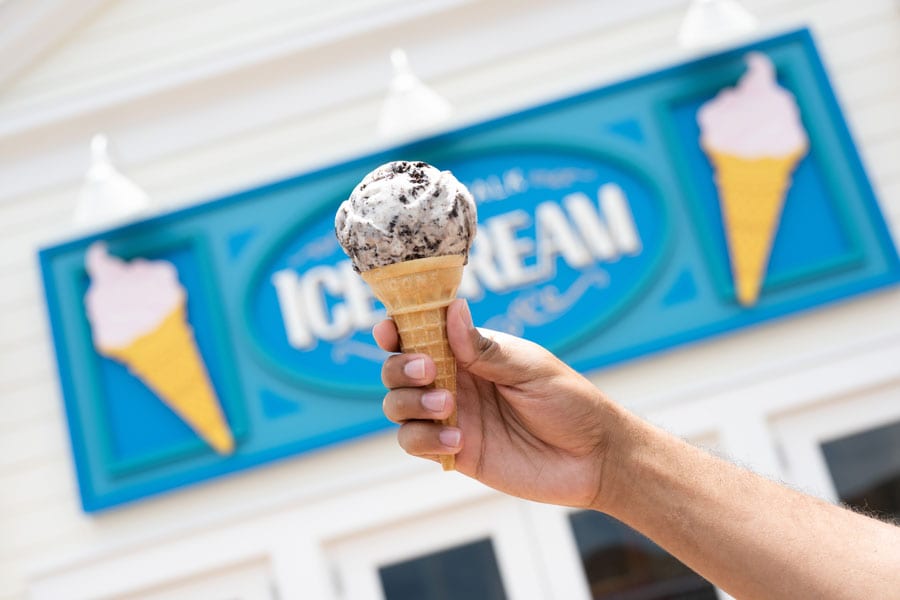 a person holding an ice cream cone at Disney’s BoardWalk at the BoardWalk Ice Cream shop