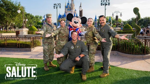 U.S. Air Force Pilots posing with Mickey Mouse wearing red, white, and blue 4th of July costume in front of Cinderella Castle