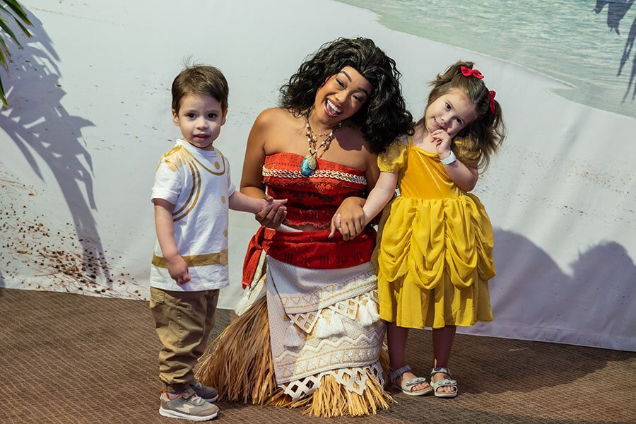 Image of two young wish kids posing with Moana during Disney World Princess Week.