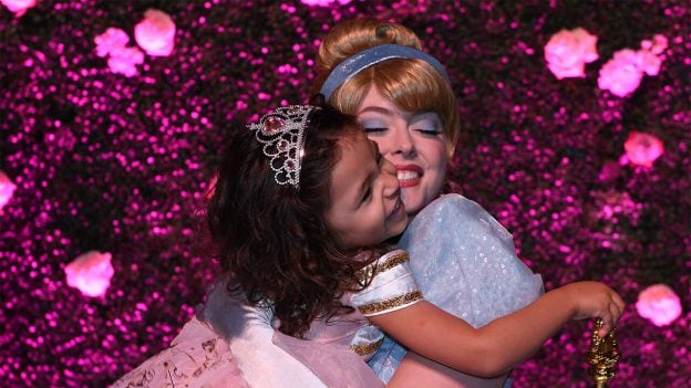Image of a Make-A-Wish kid hugging Cinderella with glee.