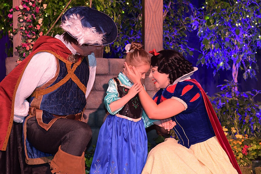 Image of a wish kid forehead to forehead with Snow White.