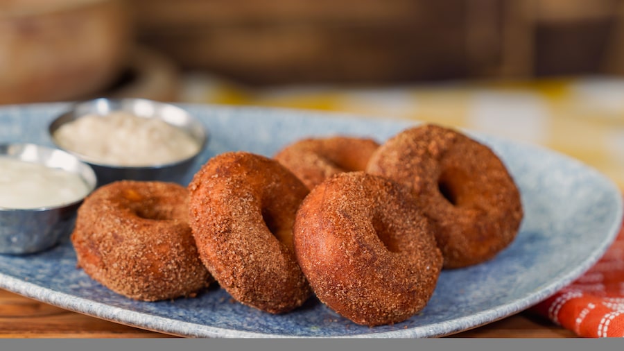 Pumpkin-spiced Donuts: Warm and fluffy donuts tossed in pumpkin-spiced sugar and served with orange cream cheese dip and hot-buttered rum sauce - Lamplight Lounge in Disney California Adventure Park 