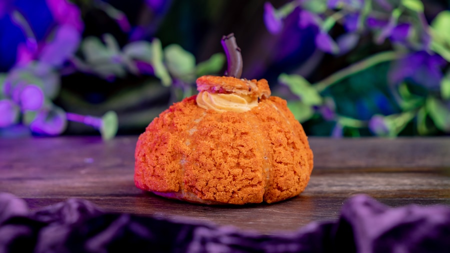 Pumpkin Chai Cream Puff: Pumpkin-shaped cream puff filled with pumpkin chai mousse and white chocolate crunchy pearls (New) at Jolly Holiday Bakery Café in Disneyland Park 